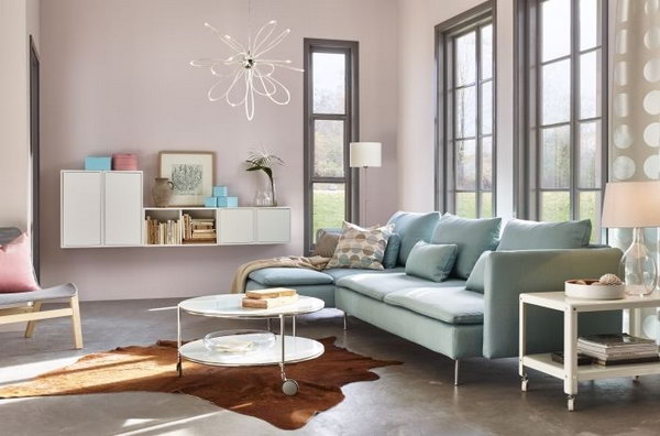 In this living room, the blue sofa goes very well with the light pink painting wall. This color combination offers a very peaceful and girlish living room for girls. The light blue sofa from IKEA next to the window provides more warmth and comfort in this living room. 