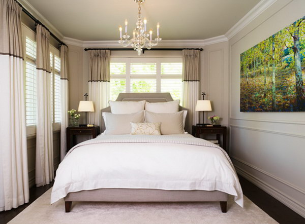 Stripes on the walls, curtains and headboard make this little gray bedroom look bigger. 