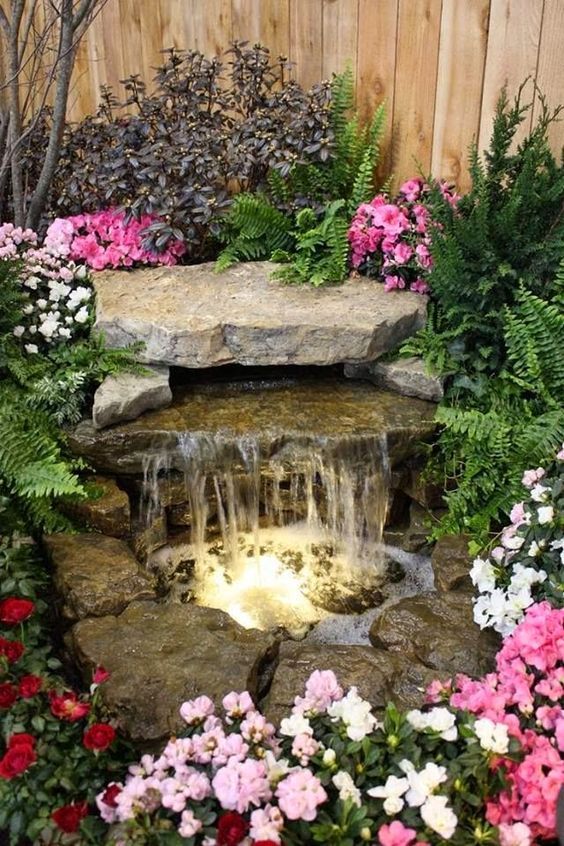 Waterfall fountain with pond and stone. 