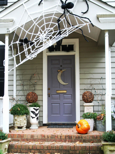 Huge spider web Halloween front door decor. 