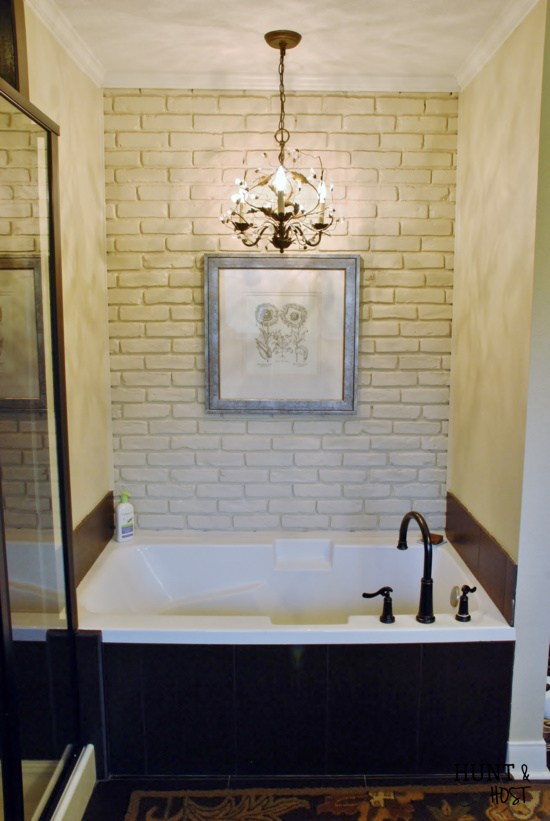White brick accent wall in the bathroom. 
