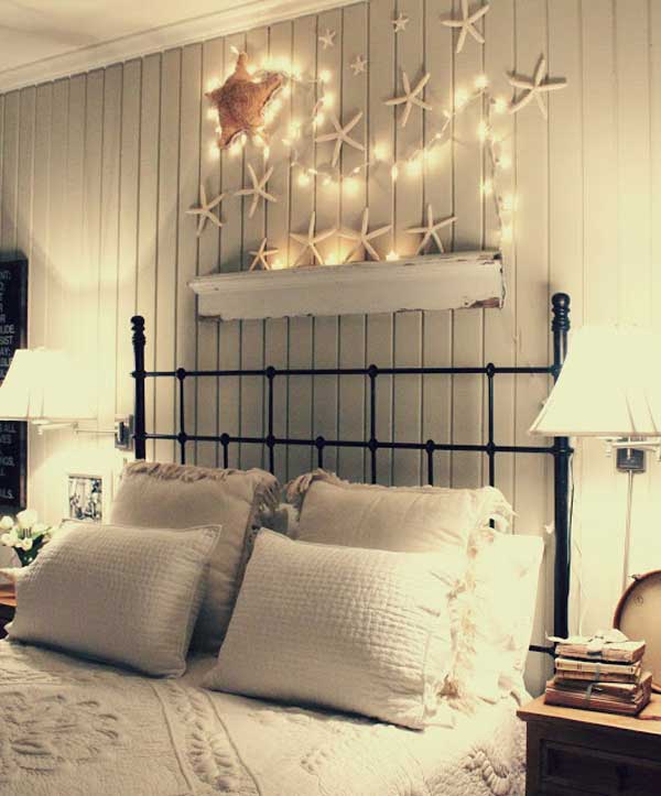 Beach theme over the bed decoration with starfish and fairy lights. 