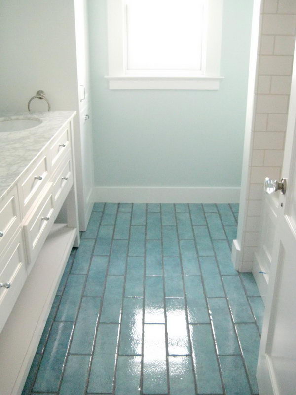 Colored tiles flooring coordinating wall color. 