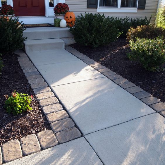 Dress up a standard entry by lining the paving stones along the sidewalk. 