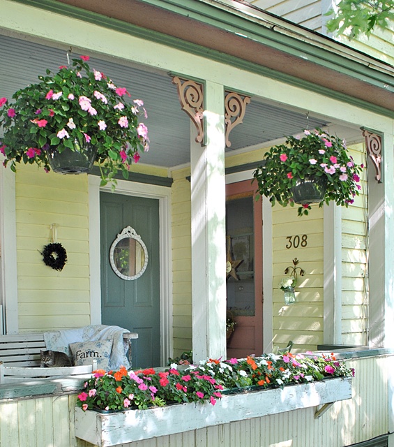Create an inviting porch with hanging baskets and flower boxes. 