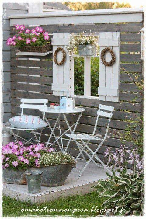 Create a seating area with pallet wood and old shutters. 