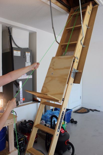 Support the attic storage using a pulley system to make loading the attic ladder easier. 
