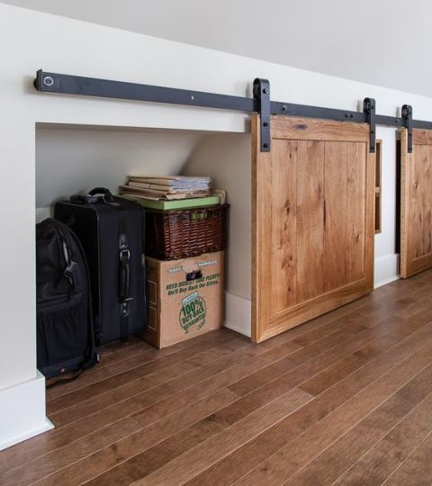 Add sliding doors to cover the knee wall storage. 