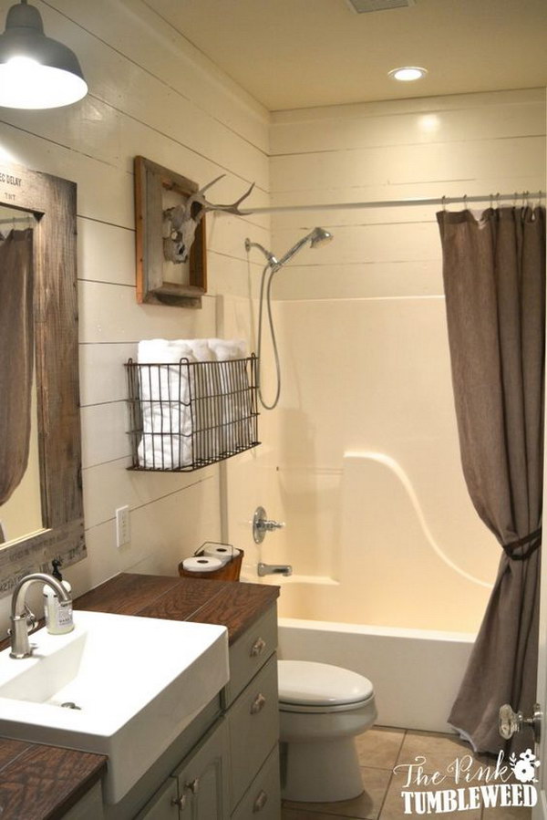Rustic bathroom with wire towel basket over the toilet. 