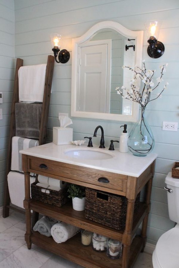 The ladder towel holder and the braided baskets give this beautiful bathroom a rustic feel. 
