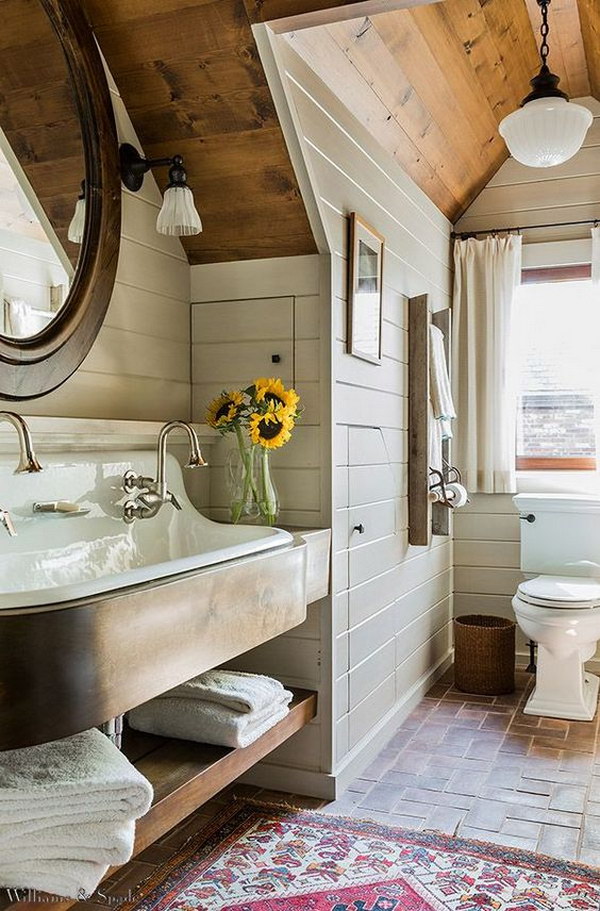Simple fresh rustic bathroom with brick floor, shiplap walls, sink and wooden ceiling 