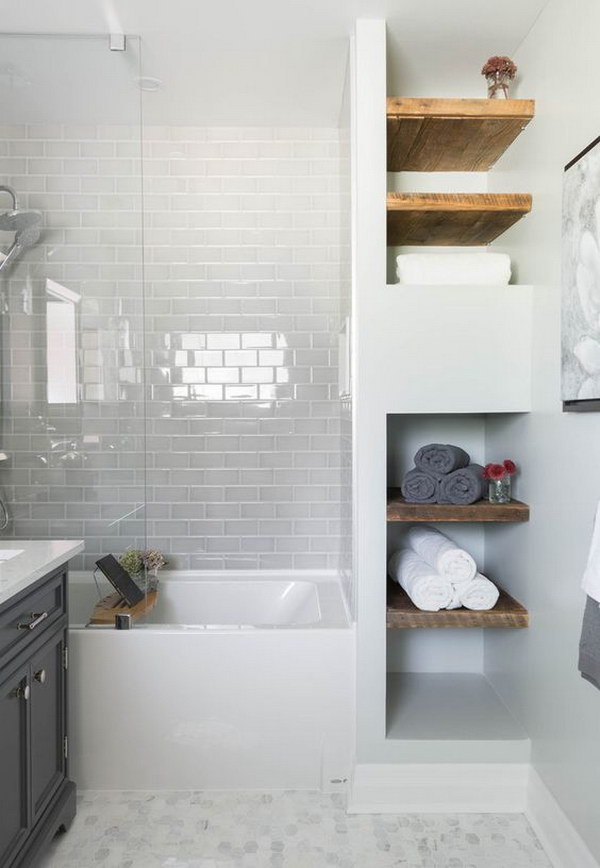 Rustic bathroom with wooden shelves, white subway tiles, mosaic floor tiles and glass shower tray 