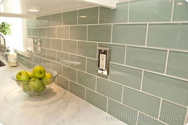 Soft turquoise glass subway tile against the Carrera marble countertops 