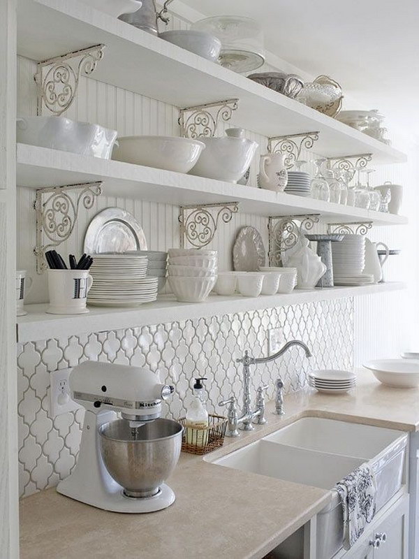 White kitchen with splashes of Moroccan tiles under the opening shelves  