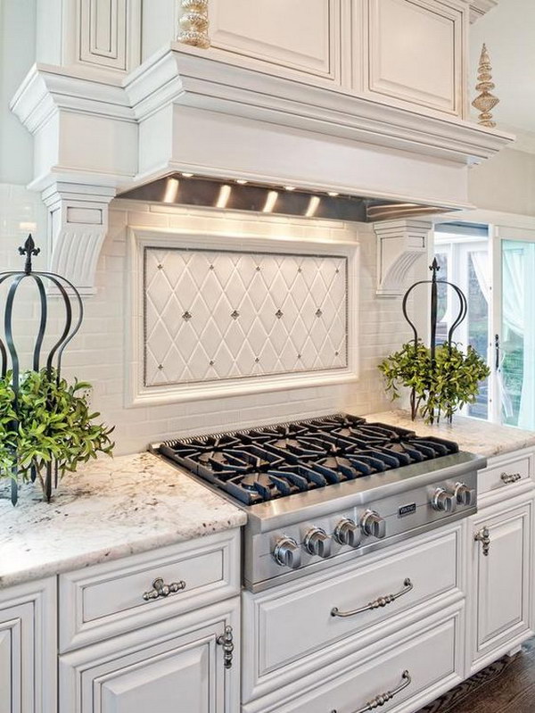 White kitchen with light gray and silver accents and a backsplash of white tiles