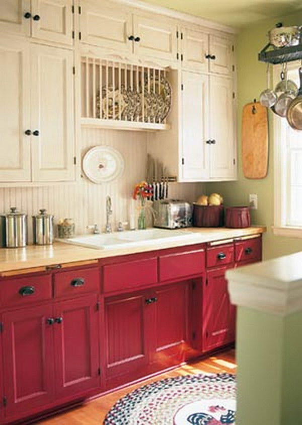 Cranberry-colored and cream-colored kitchen cabinets. 