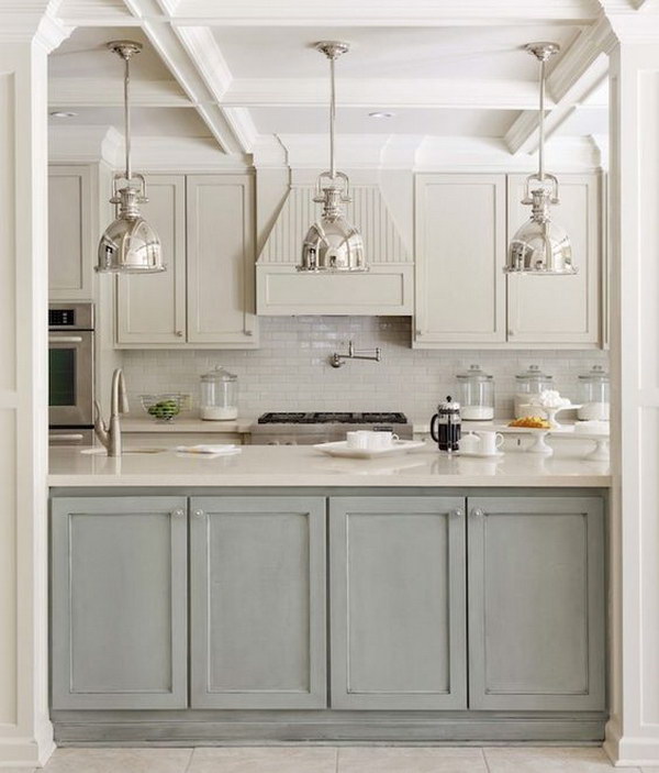 Two-tone kitchen design with gray-green and light-gray cabinets and island. 