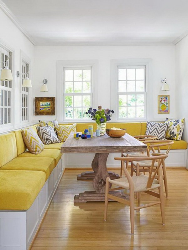 Fresh yellow pillows make this breakfast corner elegant. 