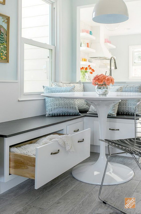 White and gray breakfast nook with built-in storage space. 