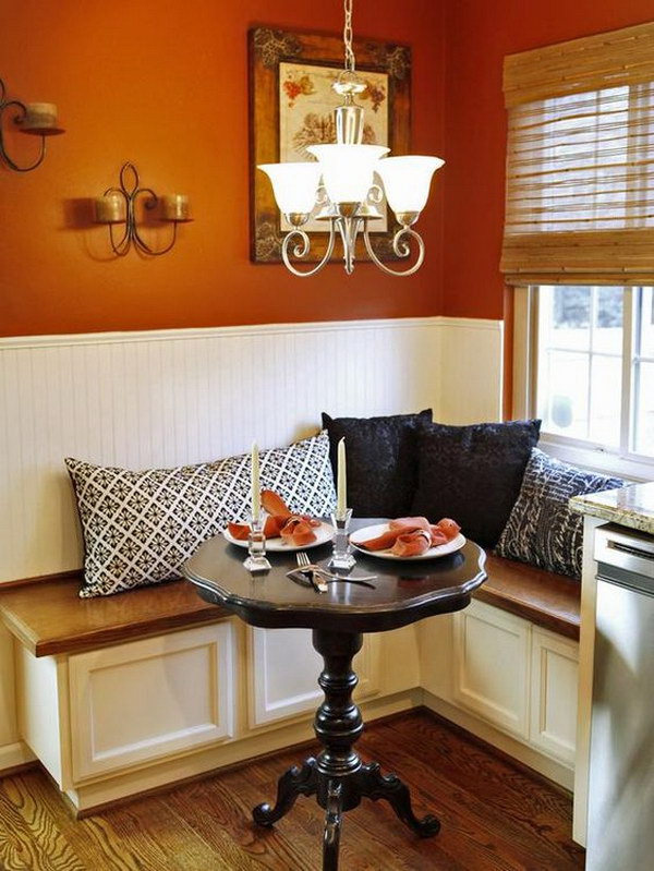 Small breakfast nook with L-shaped banquet seats. 