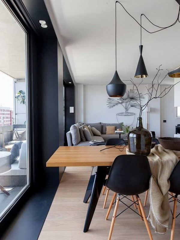 Modern living room with black chairs and lighting. 