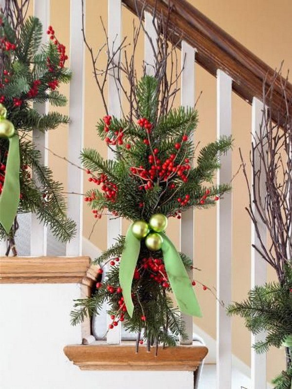 Natural Christmas decoration. Quick and easy winter decoration with evergreens, chartreuse ornaments, branches of bright red winter berries and a velvet ribbon. 