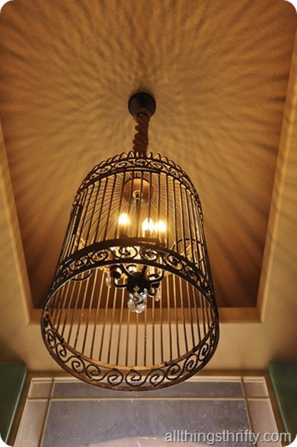 DIY gorgeous bird cage chandelier from a large bird cage. Instead of paying $ 2,300 for this Restoration Hardware birdcage chandelier, the blogger made one out of a small chandelier for $ 25 and a large birdcage to get her started.