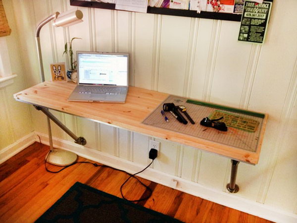 Wall desk with angled supports. This simple but impressive desk uses existing structures to save time and money. The instructions are easy to follow and make for a fantastic weekend project if you want to create a custom desk area. 