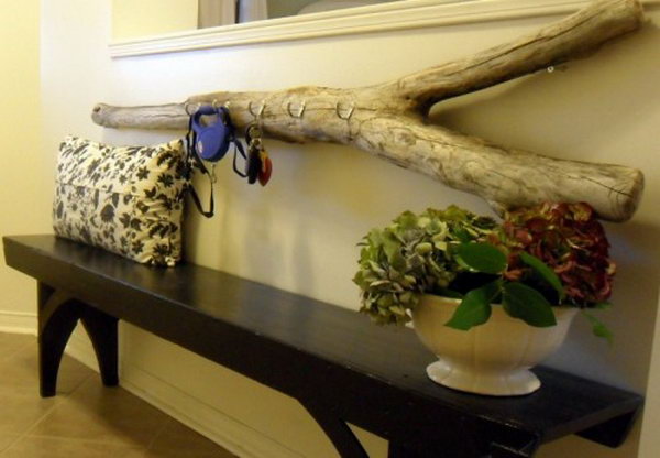 DIY driftwood key holder. Driftwood is easy to find if you live near a beach. Drill holes to accommodate all of the hooks with screws. Then hang it on your wall. It's a great place to hang your keys. You can find further instructions here  