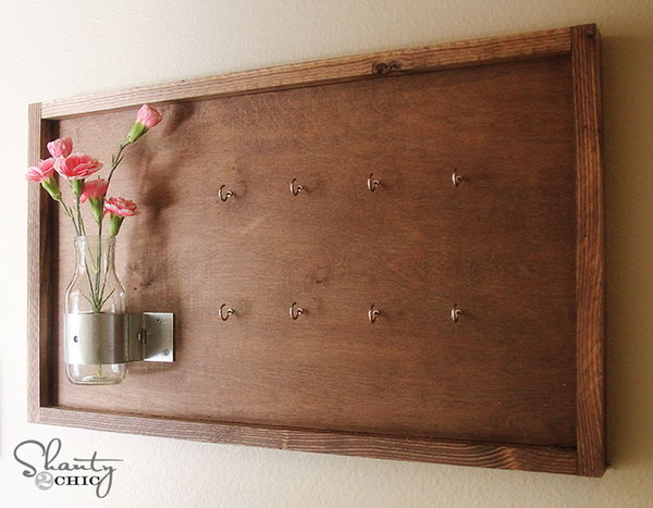DIY key holder decorated with vase and flowers. This version of a key holder has an old board, but it is decorated with vases and flowers. It looks great on the wall and beautifully replaces any painting or artwork, but also holds your keys. See more 