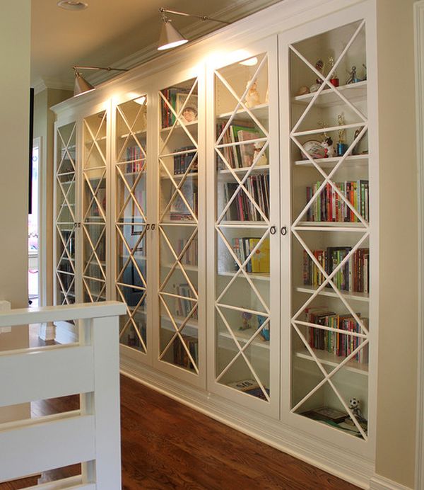     These custom-made glass doors with X motif and library lighting give these bookcases an inimitable look. This is an easy way to make sure your interiors stand out from the crowd. See more 