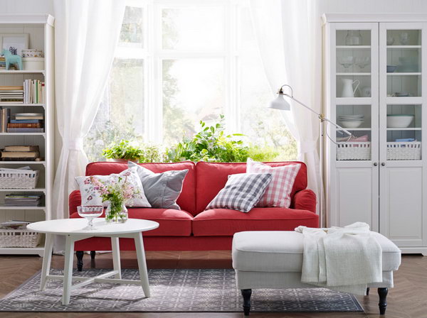 Red & white living room. Red is always associated with passion. In this living room, the red sofa from IKEA gives this calm and classic white living room an inviting and hospital-like feeling. The sofa is next to the window and the bookcase. You can enjoy the sunlight by reading something here.
