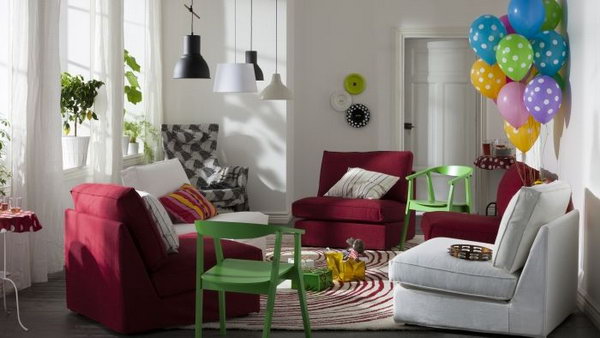 Living room cheered up by colors. Bring some light into your small living room with colorful accent furniture and accessories. Take a look at this example from IKEA. The red sofas, green chairs and colorful balloons, rainbow throws really appear in this small living room.
