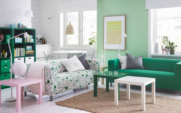Living room for green lovers. Green is used almost shockingly here. In this living area there are green bookshelves, green sofas, a green side table and a light green painted wall. If you are a green lover you can get inspiration from this decor.