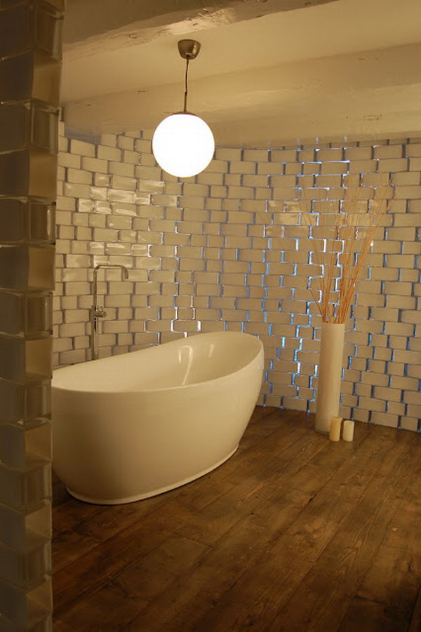 Translucent, rounded bathroom wall made from IKEA Rectangel vases. 