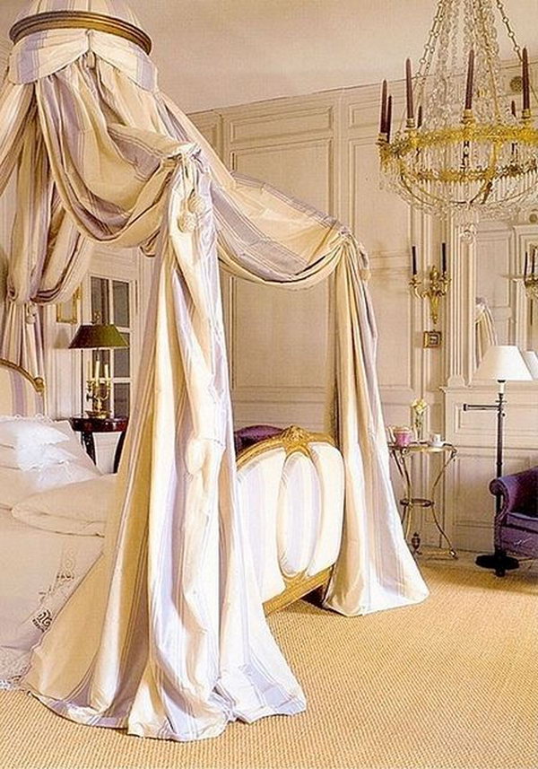 Breathtaking master bedroom: The soft, lavender-striped canopy, the perfectly decorated chandelier and the elegant wood-paneled walls, the scallop bed linen and the luxurious, gold-plated bed - so many beautiful details 
