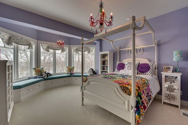 In this bedroom the color layout of lavender and white with a little green to cheer up offers a very feminine and peaceful girl's room. The four-poster bed, the arched window treatment and the hanging chandelier make the room magical for a child. 