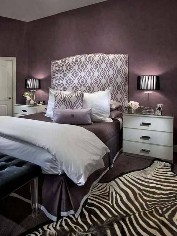 Accents for the headboard and zebra carpet: This bedroom exudes glamor, with its mixture of purple tones and the beautiful headboard and the eye-catching zebra carpet.