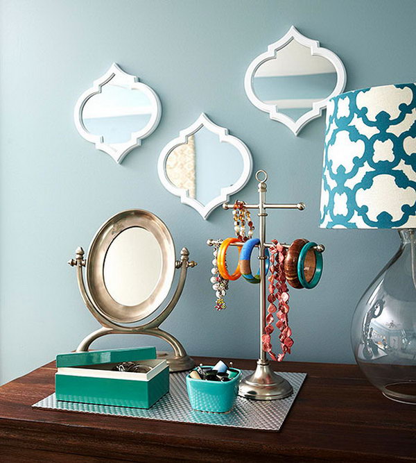 Decorative storage idea. This pretty mirror trio with a place mat to collect jewelry serves as a charming mix of decorative accents and practical storage.
