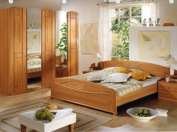 Spacious comfort. Simply set up a large wooden cabinet so that all important things are organized and your bedroom looks spacious and comfortable.