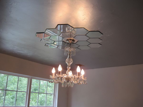     Mirrored ceiling medallion. This medallion with mirrored ceiling fits perfectly with the entire style of the bedroom and provides more elegance. With little imagination, you can make candlesticks from the Hobby Lobby yourself for around $ 30. 