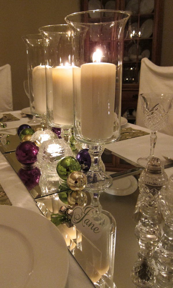 Mirror as a table runner. Check out this amazing table with jingle bells and candles. It also shows the mirror as the table's runner. It looks super pretty with the candlelight reflected from the mirror. 