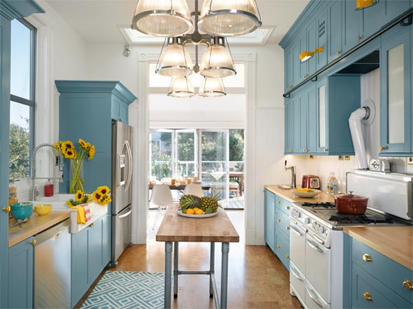     Bright kitchen. The galley is open to the sun and is now blue and white and bright. The focus is on an existing vintage Wedgewood stove. 