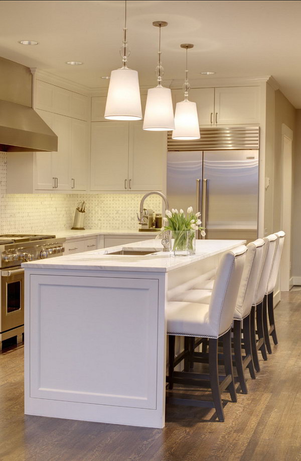     A glimpse of hope. A white island with simple lines is reminiscent of the white charms of this kitchen and the white, elegant, custom-made chairs. Stainless steel devices ensure a very stylish and grumpy look. 