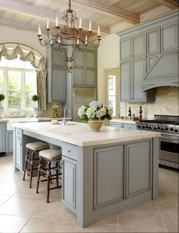     Pastel colored kitchen. The colors are warm and so pleasant and relaxing. This kitchen island is accented with beautiful classic green cabinets and lighting fixtures.