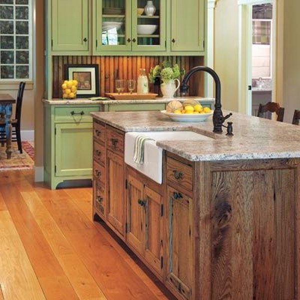     Kitchen on the farm in the old country. The wood-colored vintage island gives this green kitchen a farm look. And the black sink above would really make the island's colors flow.