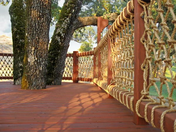 Rope net deck railing. Very creative way to use rope as a cover baluster. And the rustic wooden and rope deck railing offers a great view. Really great idea. 