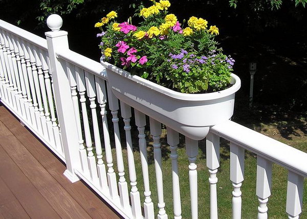     White traditional railing with planters. This white railing is really richly decorated, but I especially love the planters. The flash of color in the flowers gives a beautiful look that underlines the beauty of your railing. 