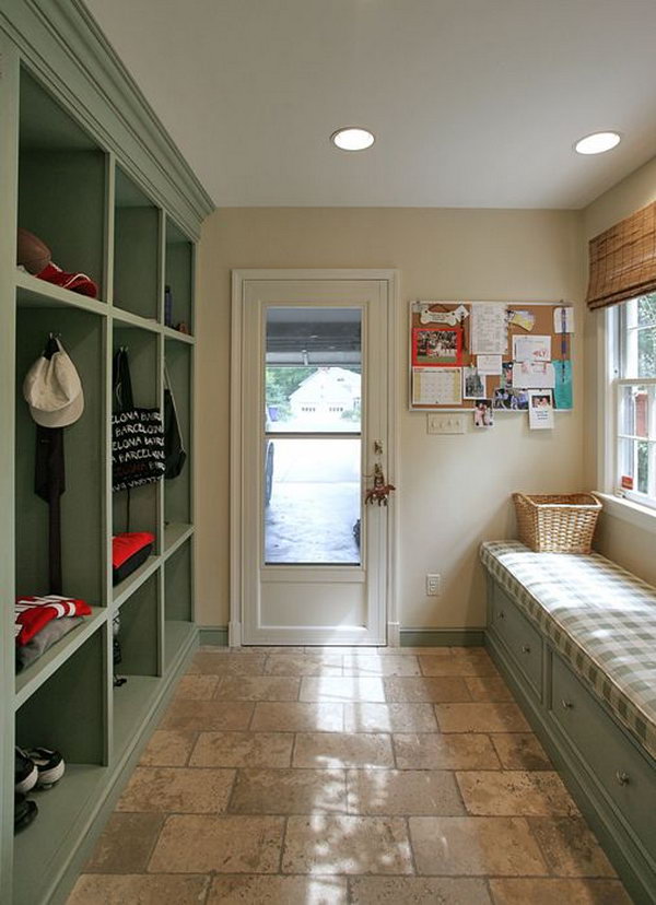     Pastel colored mud room. Adorable green and cream colored layout. This is a great place for family members to put their shoes, coats, cats and backpacks. Gray tiles are easy to clean. 