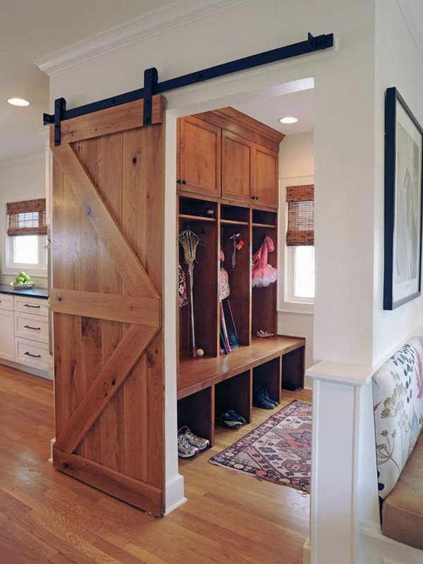     Wood mudroom. I love this area of ​​the house very much. It is really adorable with the warm wood color, the great barn door with a view of the mud room, the wooden floor, the shoe rack, the bench, the hook and the extended top shelf for hats. 